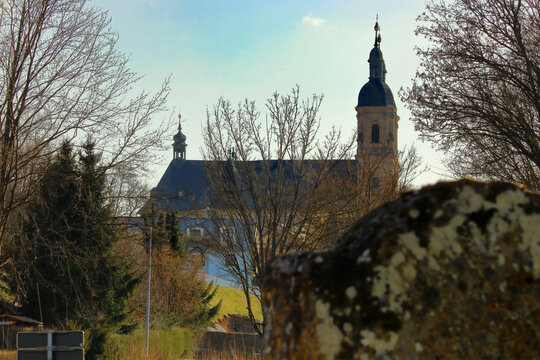 basilica in an upper franconian town behind soe bare trees