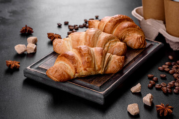 Fresh crisp delicious French croissant with a cup of fragrant coffee
