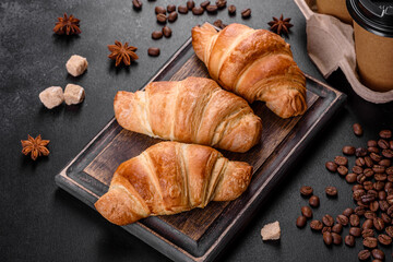 Fresh crisp delicious French croissant with a cup of fragrant coffee