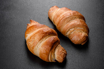 Fresh crisp delicious French croissant with a cup of fragrant coffee