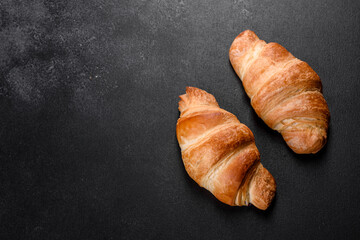 Fresh crisp delicious French croissant with a cup of fragrant coffee