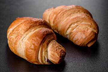 Fresh crisp delicious French croissant with a cup of fragrant coffee