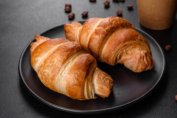 Fresh crisp delicious French croissant with a cup of fragrant coffee