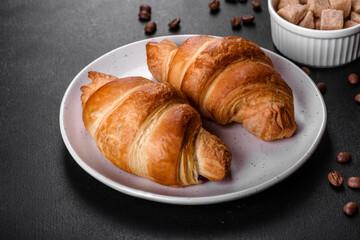 Fresh crisp delicious French croissant with a cup of fragrant coffee