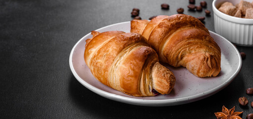 Fresh crisp delicious French croissant with a cup of fragrant coffee