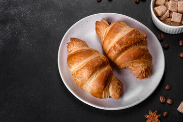 Fresh crisp delicious French croissant with a cup of fragrant coffee