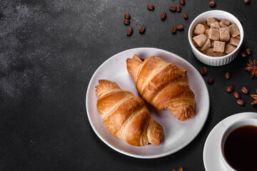 Fresh crisp delicious French croissant with a cup of fragrant coffee