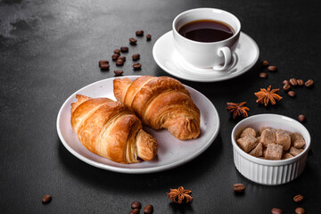 Fresh crisp delicious French croissant with a cup of fragrant coffee