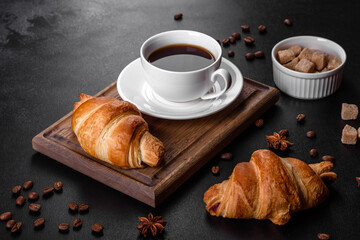 Fresh crisp delicious French croissant with a cup of fragrant coffee