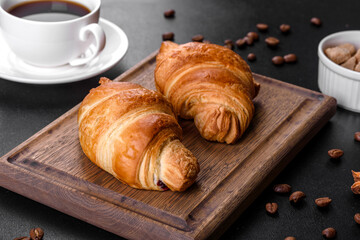 Fresh crisp delicious French croissant with a cup of fragrant coffee