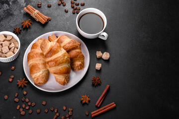 Fresh crisp delicious French croissant with a cup of fragrant coffee