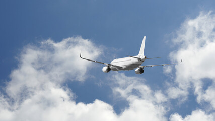 Fototapeta na wymiar Zoom photo of passenger plane flying above deep blue cloudy sky