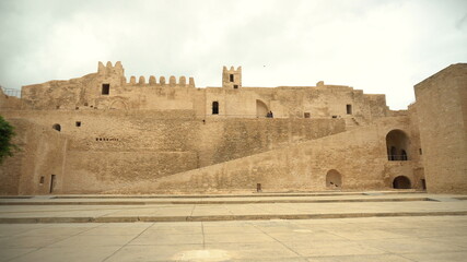 Passage inside the ancient Ribat fortress in Monastir, Tunis. Old yellow bricks. View from right to...