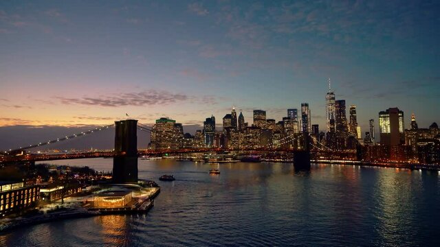 Panoramic view of Brooklyn bridge and Manhattan at night, New York City.