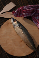 Smoked mackerel on a wooden stand. Appetizing fish. Rustic concept. 