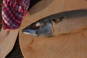 Smoked mackerel on a wooden stand. Appetizing fish. Rustic concept. 