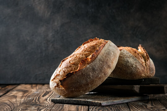 Fresh homemade sourdough bread on a rustic background with copy space.