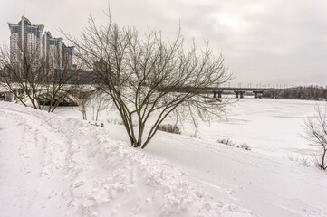 Old Paton Bridge over the Dnieper River and the city of Kiev, Ukraine. Frozen cityscape in winter