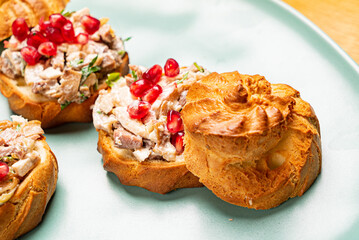 canape with meat salad and pomegranate seeds