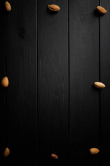 nuts on the wooden black background