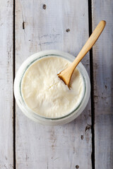 Traditional creamy yoghurt. Turkish and Greek traditional dairy food yogurt or yoghurt in bowl on wooden background.