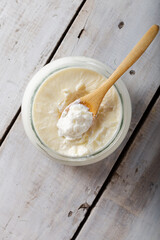 Traditional creamy yoghurt. Turkish and Greek traditional dairy food yogurt or yoghurt in bowl on wooden background.