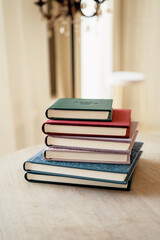 Photo album for photos. Color modern books diaries in the office on the table. A notebook for teaching school records and events. Copy space.