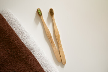 bamboo toothbrush with towel flat lay. eco friendly dental oral tools.