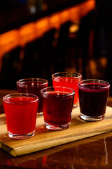 Colourful set of alcoholic cocktails in shot glasses shooters