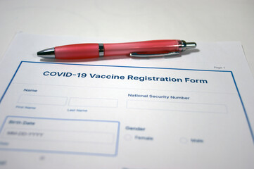 Covid-19 vaccine registration form and pen