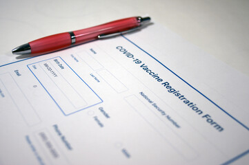 Covid-19 vaccine registration form and pen