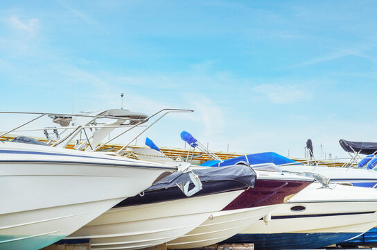Boats on stand on the shore, luxury  yachts and ships, maintenance and parking place boat