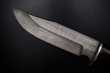Knife of Damascus steel. Patterned blade close-up.