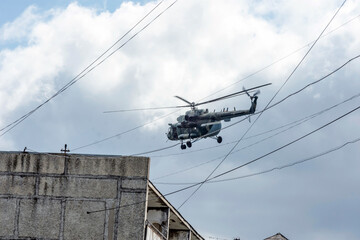 Military helicopter mi8 flies over the city