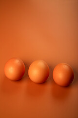 chicken egg on a beige background. Three brown eggs. Easter minimalistic concept.