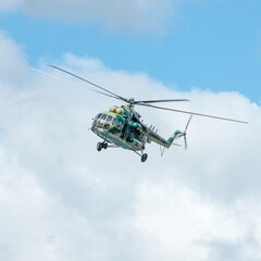 Fototapeta na wymiar Military helicopter mi8 flies in the clouds