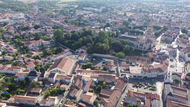 Picturesque summer view of Lucon looking out over Roman Catholic cathedral with tall Gothic bell tower, France