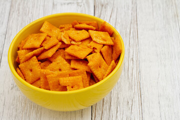 Cheese square crackers in bowl on table