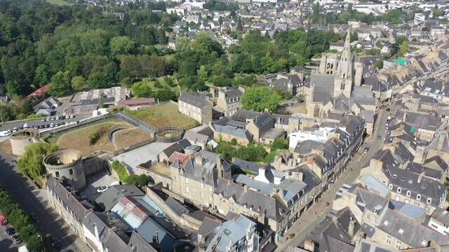 Flight over the city Guingamp and Basilica of Our Lady of Merciful on summer day. France