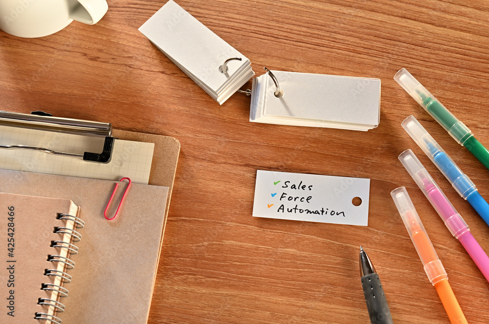 Aufkleber there is a a word card with sales force automation written on it. they are on the desk along with st