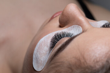 Woman Eyes with Long Eyelashes Extension and under eye mask patch . Lashes.