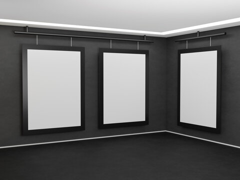 Three images hang on a dark gray concrete wall in the corner of the room. Poster template with black frame. 3D rendering mockup for art gallery.
