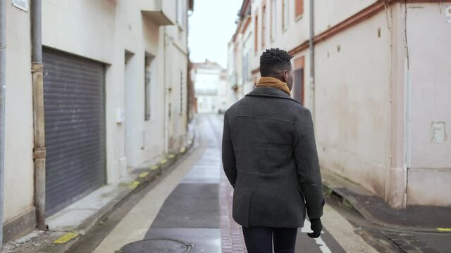 Confident back of black elegant black African man walking