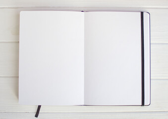 White empty sketchbook pages on white wood