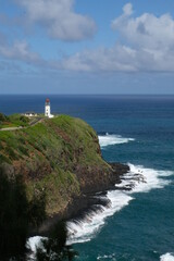 A lighthouse stands against the Pacific on the island of Kauai
