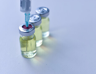 Vial of drugs injection or vaccine with syringe needle on a white background for cure and prevention of sickness 