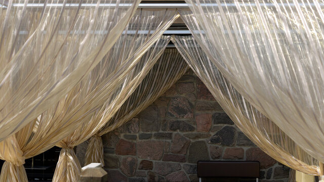 Diaphanous Golden Drapes On An Outdoor Patio Cafe 