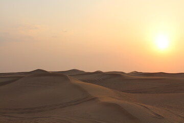 Obraz na płótnie Canvas Little girl looking at the Sunset at Dubai's Desert by Christian Gintner