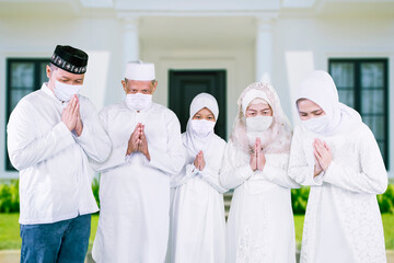 Muslim family in face mask show congratulate hands