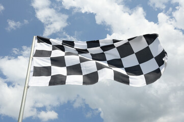 checkered flag on blue sky background